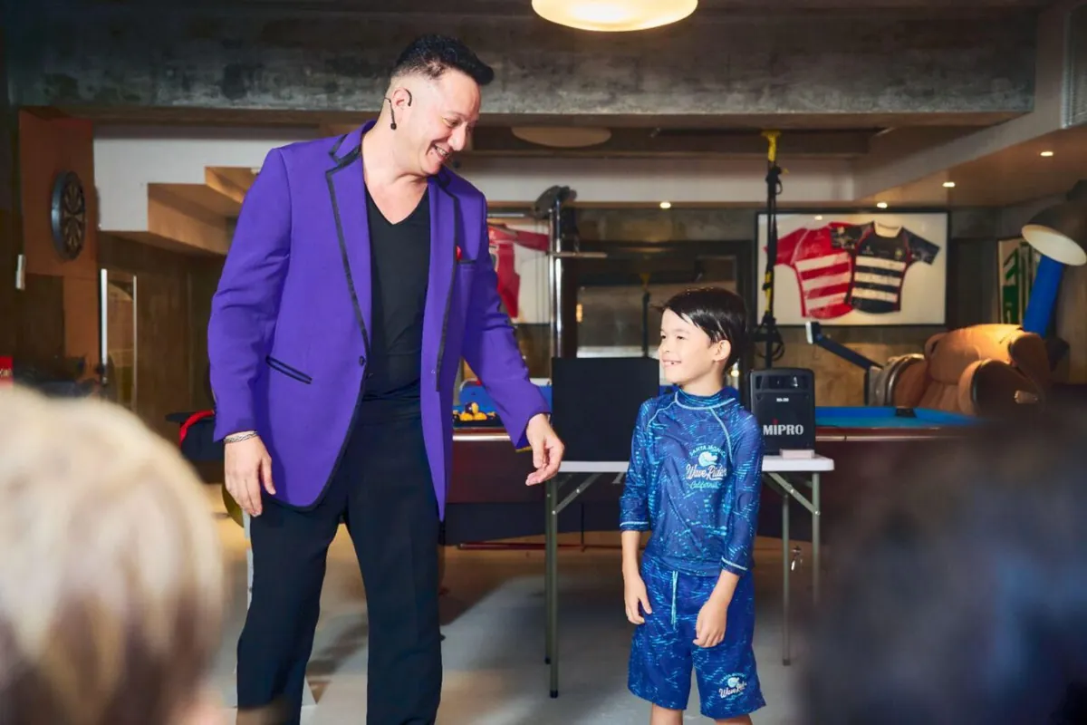 Birthday party magic show with children laughing