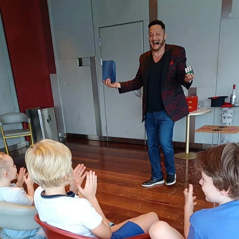 Jose making children laugh during a magic show