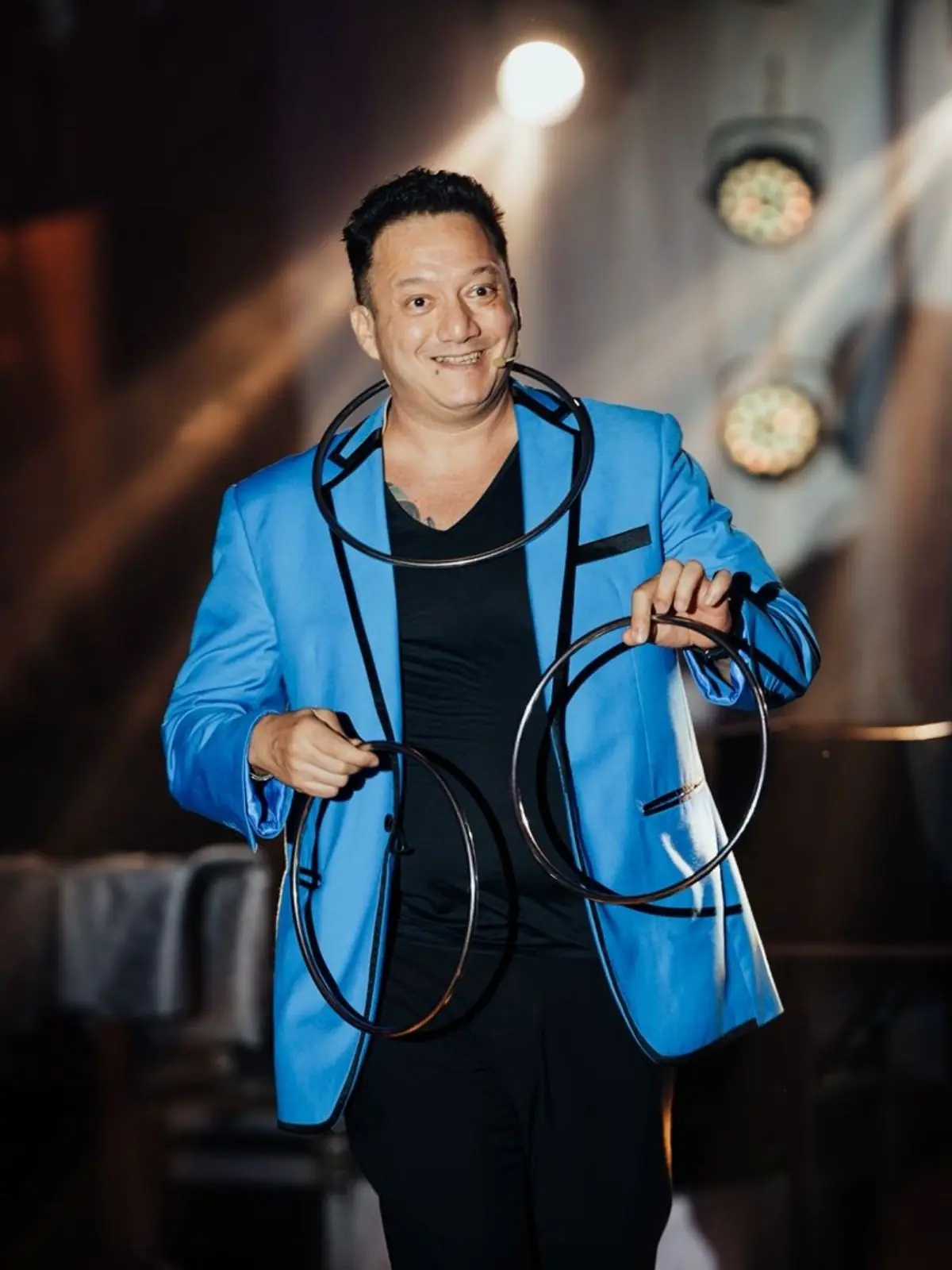 Jose performing on stage with full audience